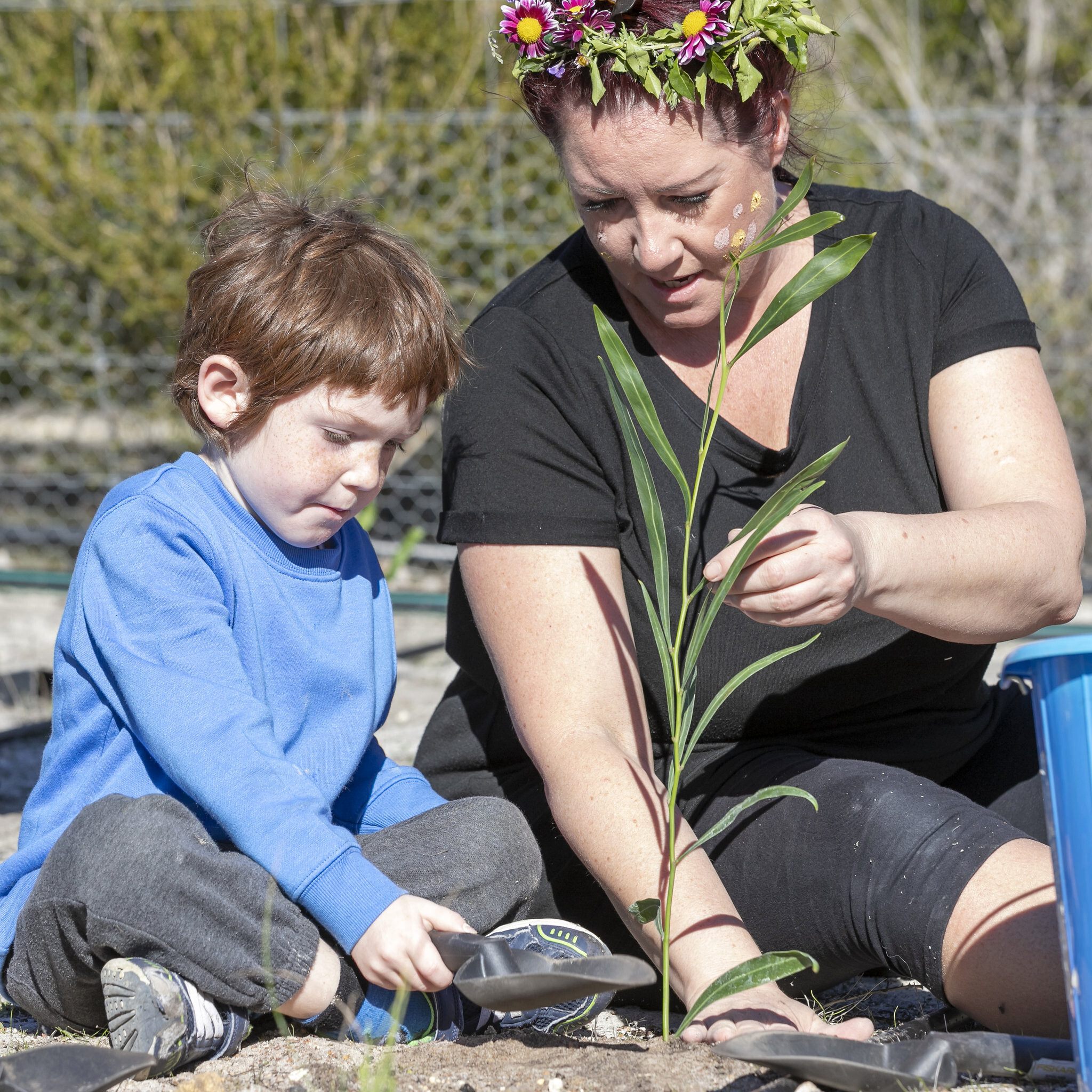 Children's Forest - mum and son planting }}