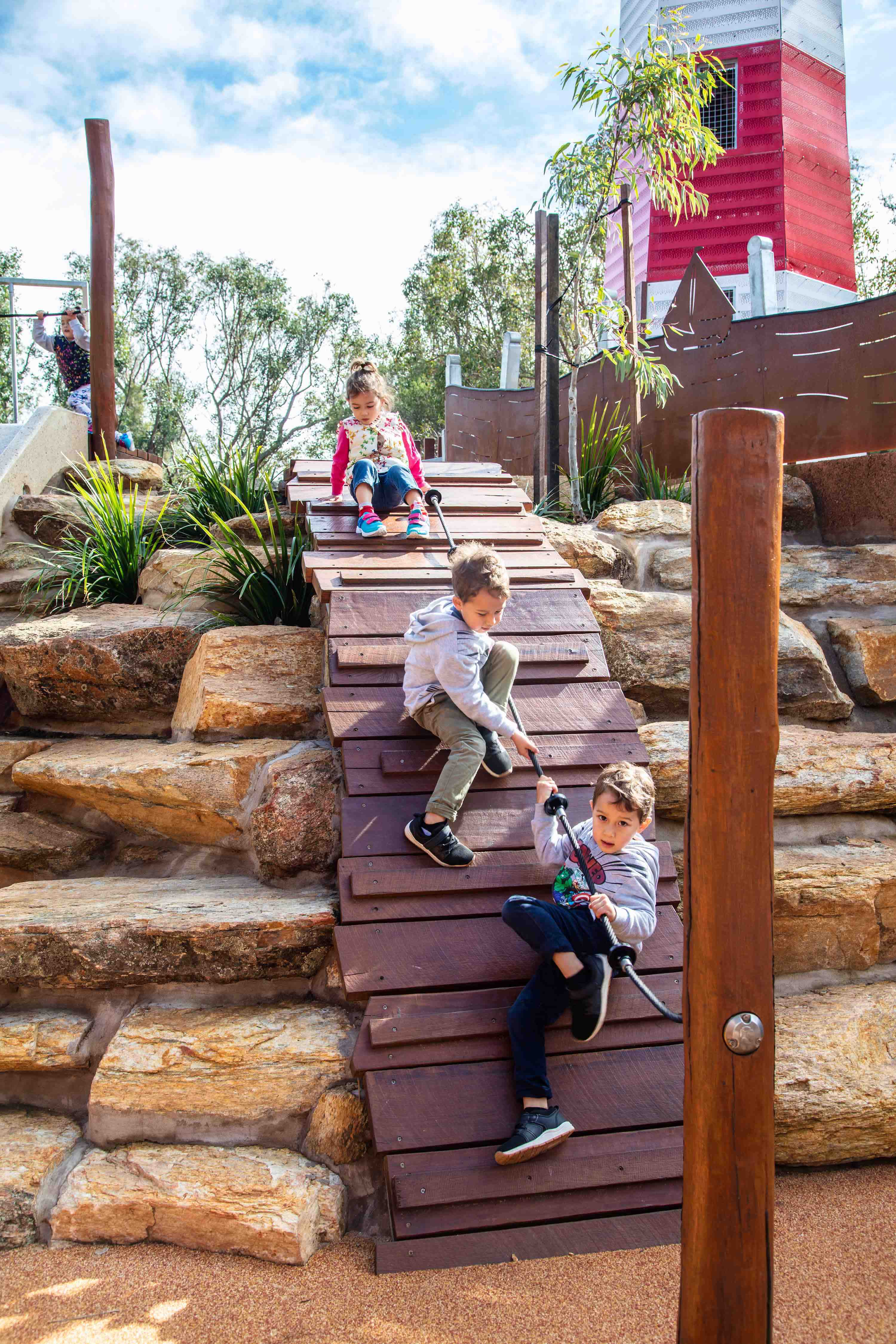 Pias Place kids climbing the base of the tower }}