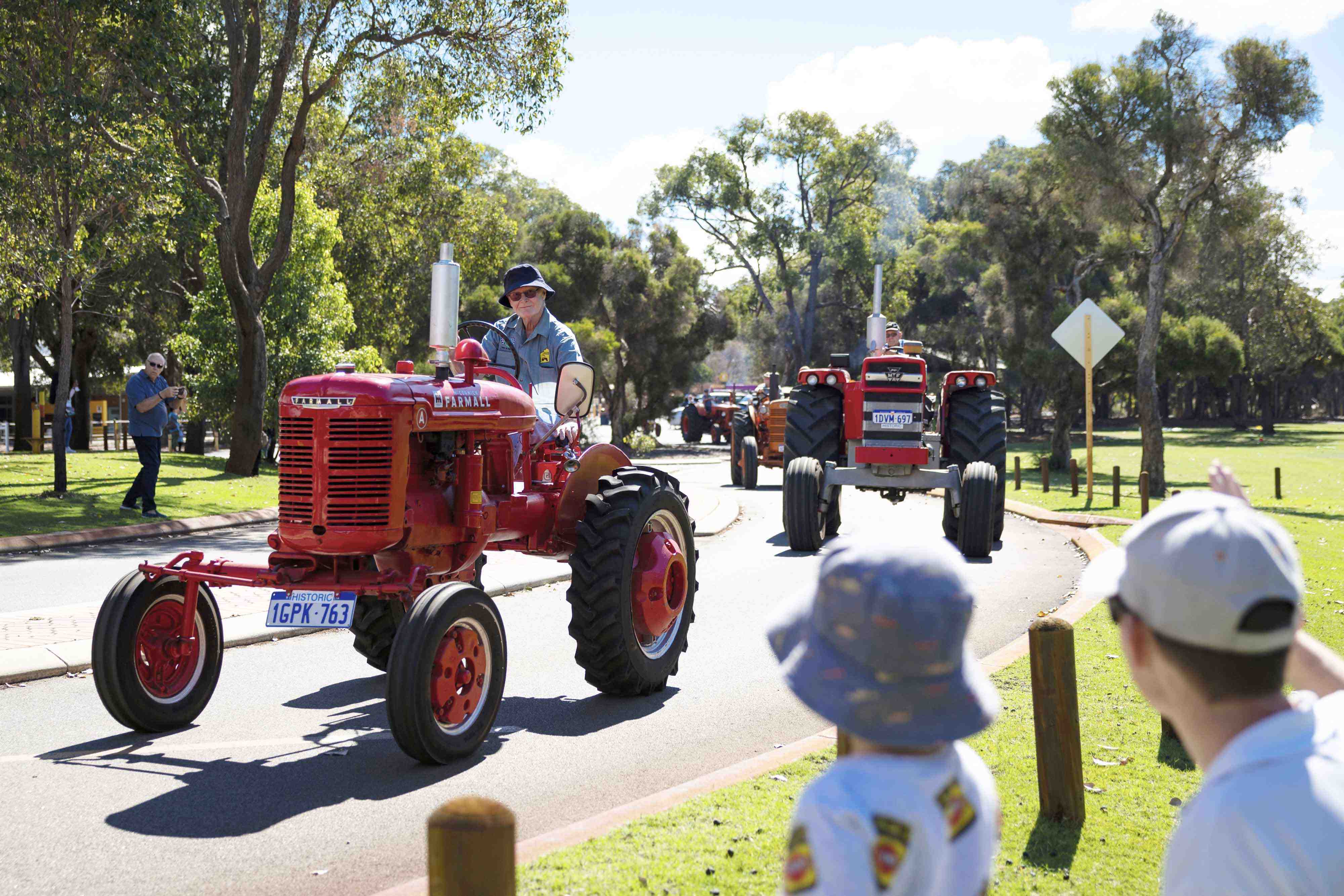 The Tractor Parade near the Village Junction Station with onlookers }}